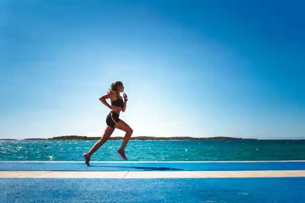Woman running showing strong leg muscle Preston